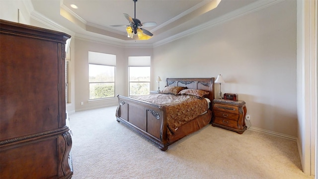 bedroom featuring ceiling fan, light colored carpet, a raised ceiling, and ornamental molding