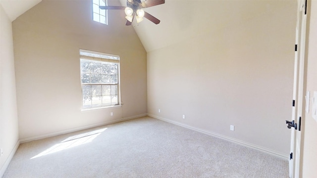 carpeted empty room with high vaulted ceiling and ceiling fan