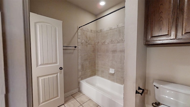 bathroom with tiled shower / bath combo, toilet, and tile patterned flooring