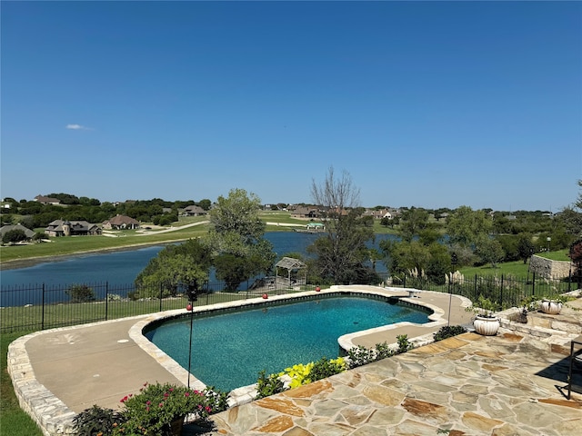 view of swimming pool featuring a patio and a water view