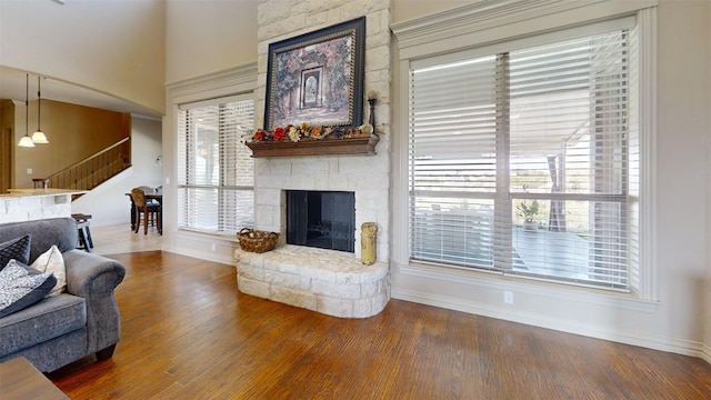 living room with dark hardwood / wood-style floors and a fireplace