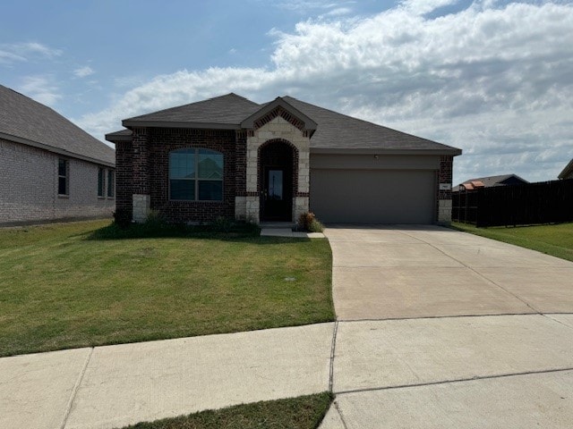 view of front facade featuring a front lawn and a garage