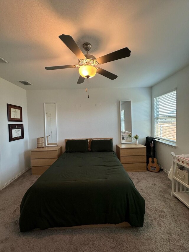 carpeted bedroom featuring ceiling fan