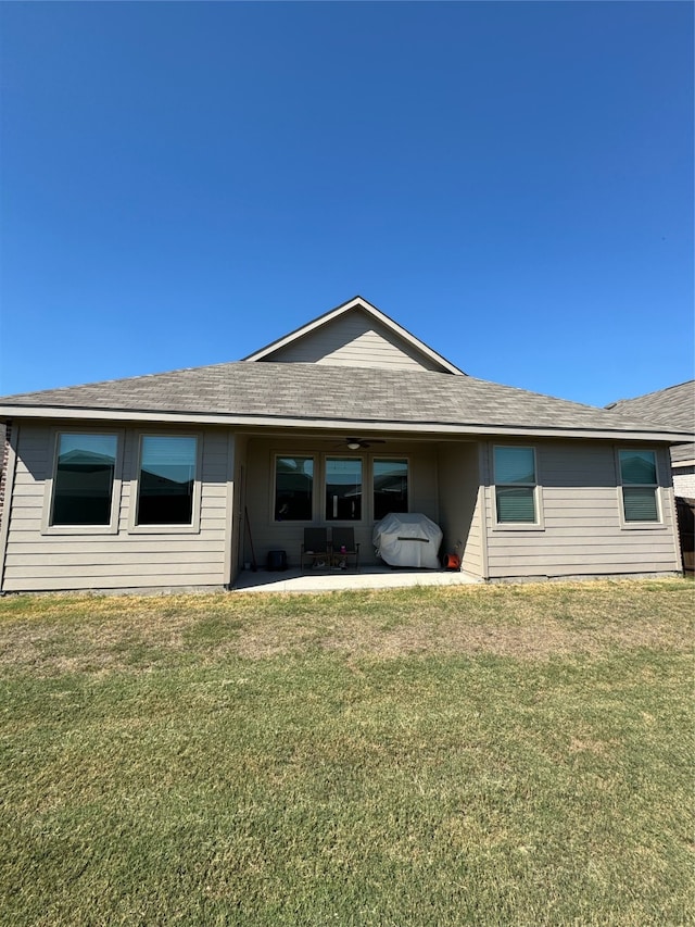 rear view of property with a yard and a patio area