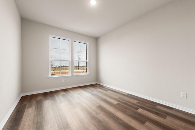 unfurnished room with wood-type flooring