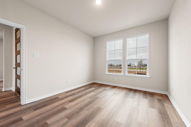 spare room with hardwood / wood-style flooring