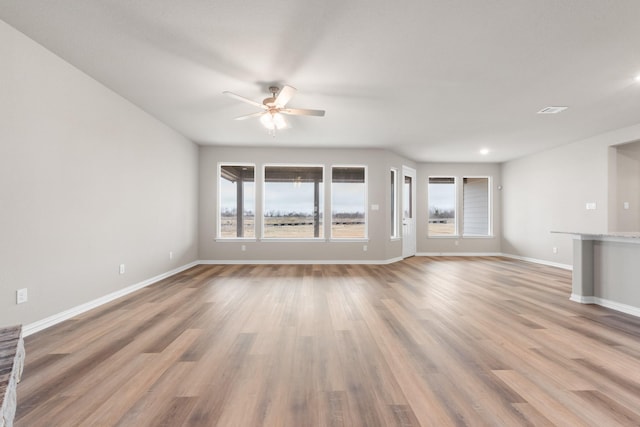 unfurnished living room with ceiling fan and light hardwood / wood-style floors