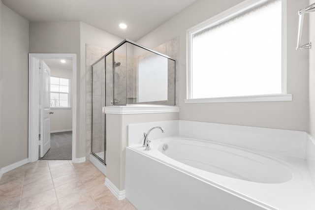 bathroom with tile patterned flooring and independent shower and bath