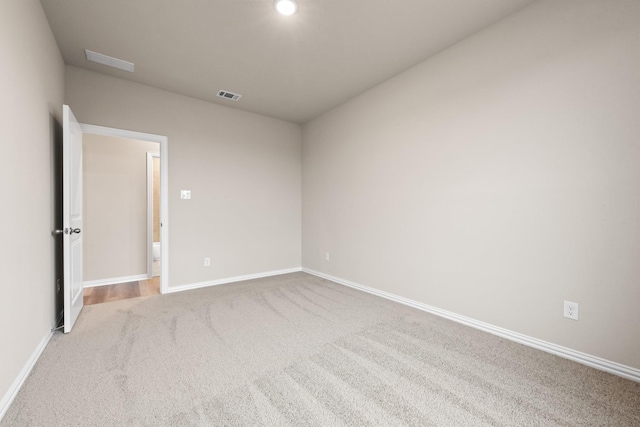 empty room featuring light carpet