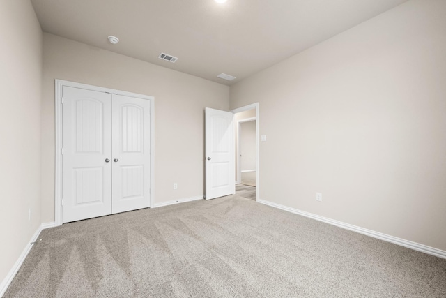 unfurnished bedroom with carpet floors and a closet