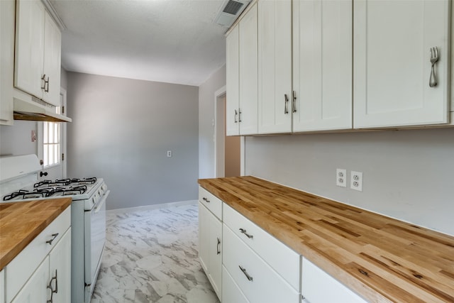 kitchen with gas range gas stove, white cabinetry, and wooden counters