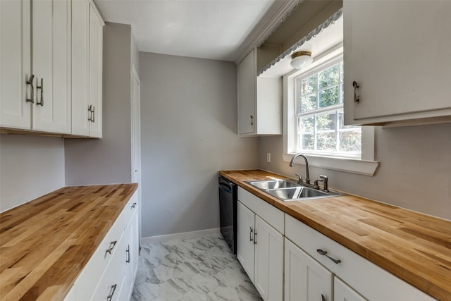 kitchen featuring butcher block countertops, white cabinets, dishwasher, and sink