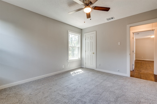 unfurnished bedroom featuring a textured ceiling, wood-type flooring, and ceiling fan