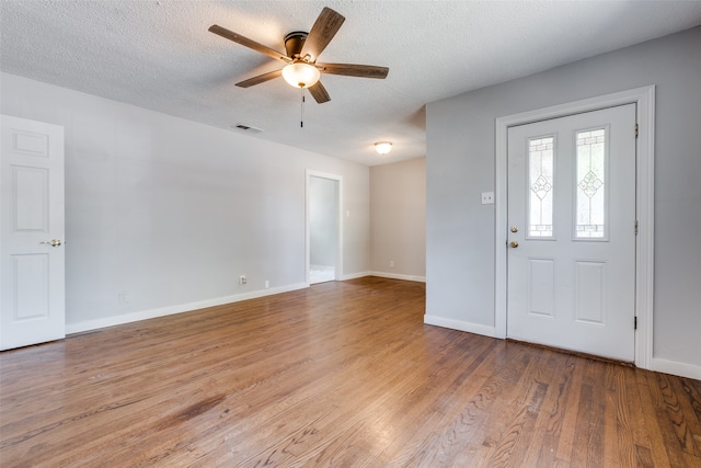 entrance foyer with a textured ceiling, light hardwood / wood-style flooring, and ceiling fan