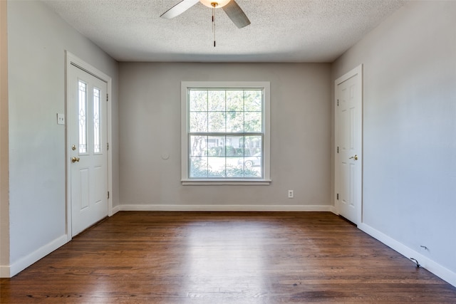 foyer featuring ceiling fan, dark hardwood / wood-style floors, and a textured ceiling