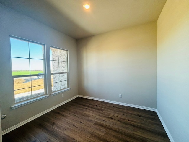 empty room featuring dark wood-type flooring