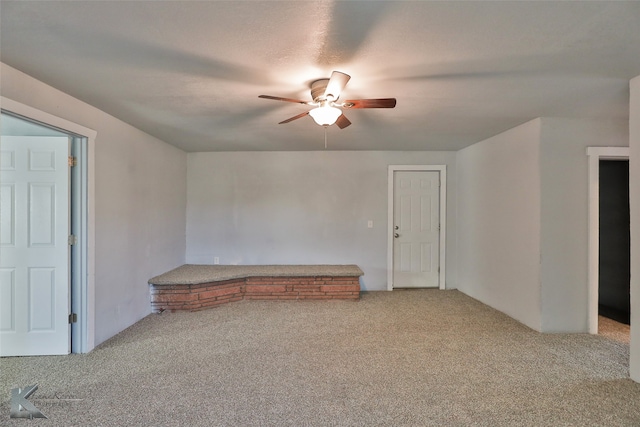 spare room featuring carpet flooring and ceiling fan