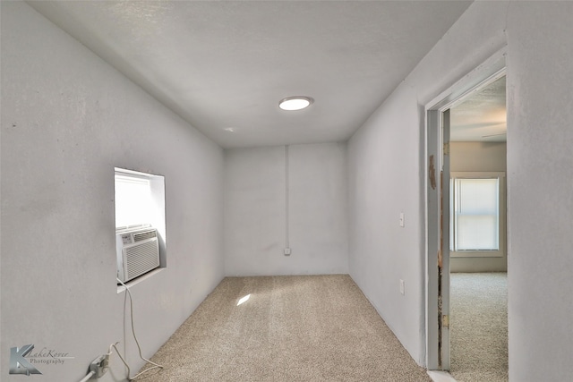 unfurnished room with cooling unit and carpet floors