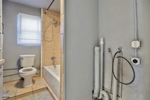 full bathroom with toilet, tiled shower / bath combo, vanity, and tile patterned flooring