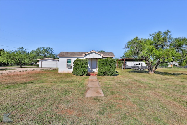 view of front of home featuring a garage, a wooden deck, and a front lawn