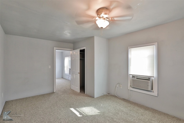 spare room featuring ceiling fan, cooling unit, and light carpet