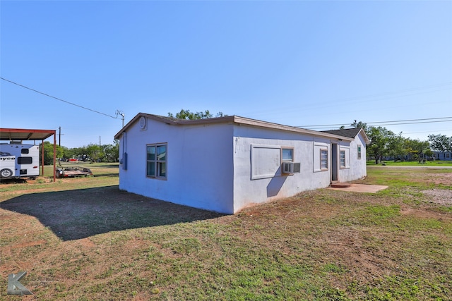 view of side of property with a lawn