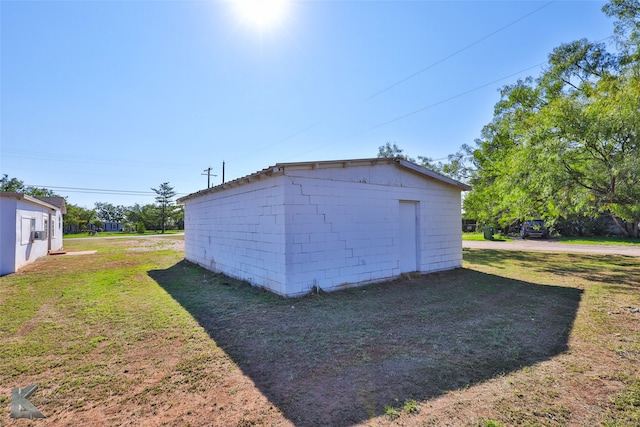 view of outbuilding with a yard