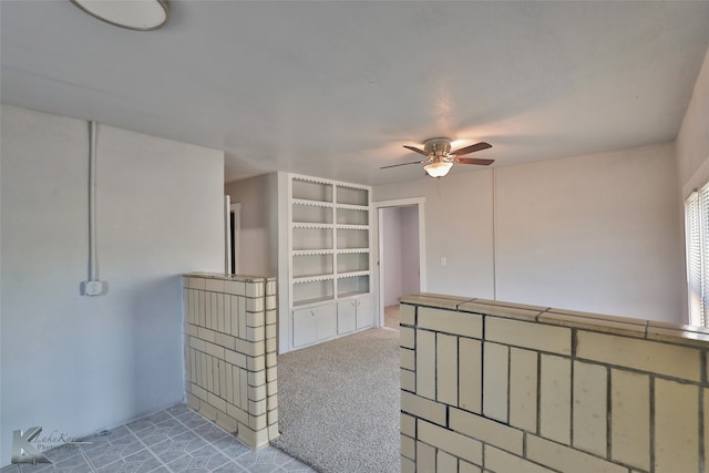 empty room featuring light colored carpet and ceiling fan