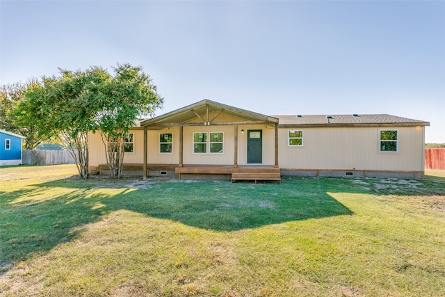 back of property featuring crawl space, a yard, and fence