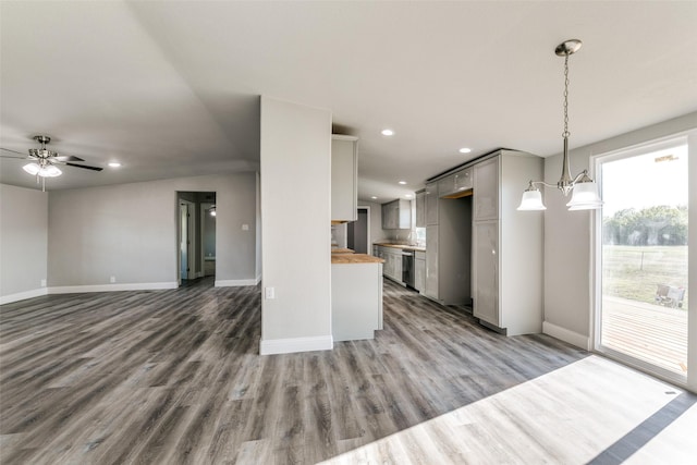 kitchen with wood finished floors, open floor plan, recessed lighting, baseboards, and dishwasher