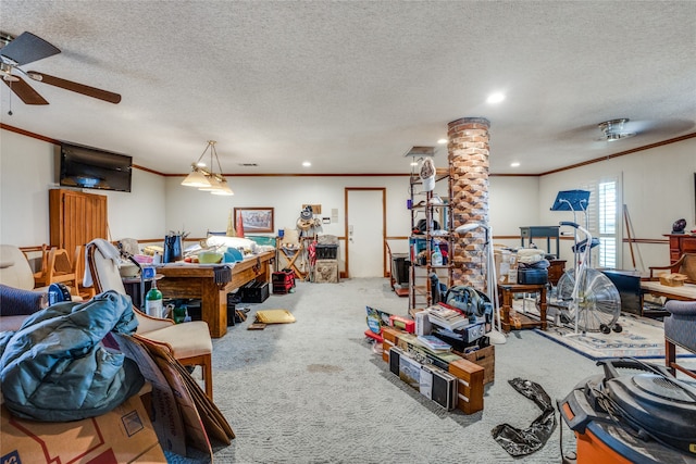 living room featuring carpet flooring, ceiling fan, ornamental molding, and a textured ceiling