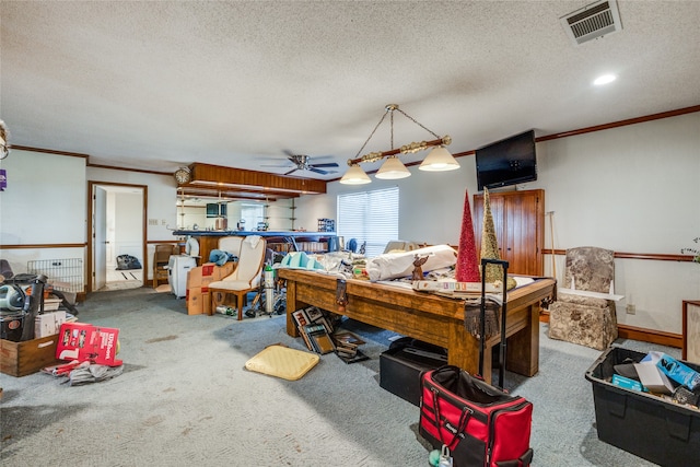 interior space with ceiling fan, ornamental molding, a textured ceiling, and carpet floors