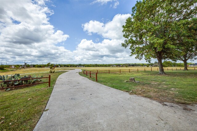 view of home's community with a yard and a rural view