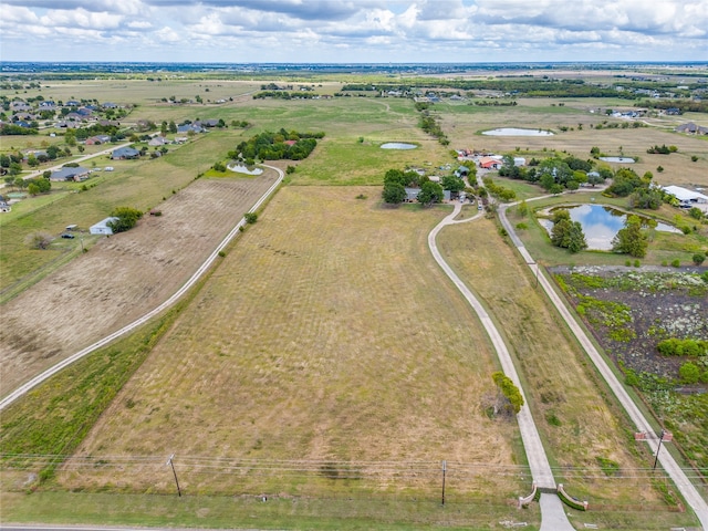 drone / aerial view featuring a water view and a rural view