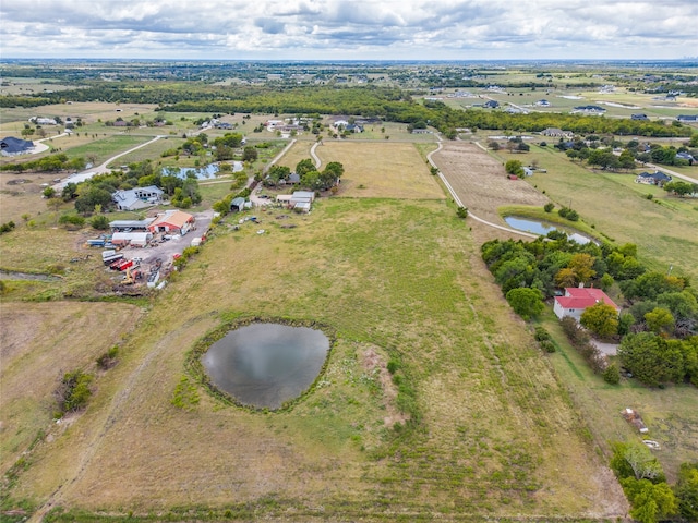 drone / aerial view featuring a rural view and a water view