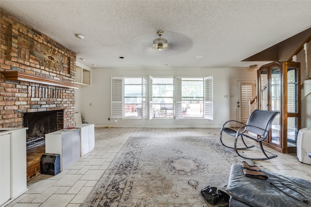 unfurnished living room with a textured ceiling, a brick fireplace, and ceiling fan