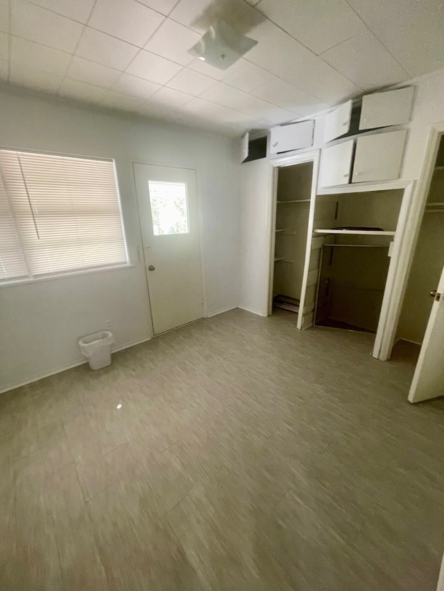 unfurnished bedroom featuring a closet and hardwood / wood-style floors