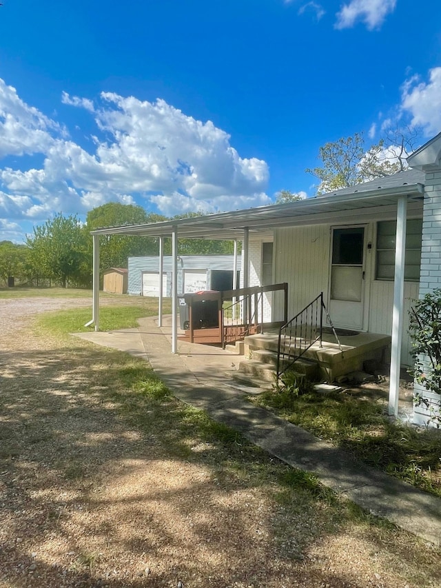 back of property with covered porch and a carport