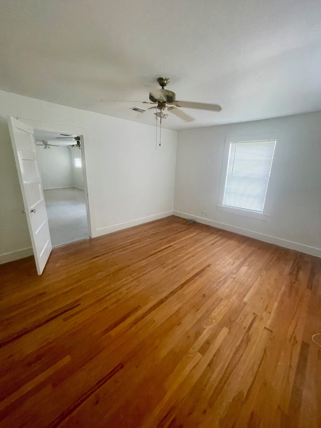 unfurnished bedroom with ceiling fan and hardwood / wood-style flooring