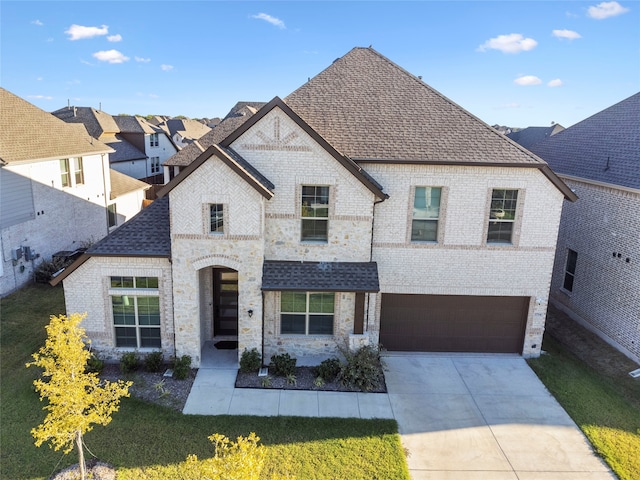 view of front of property with a front lawn and a garage