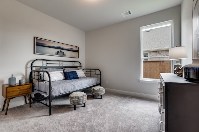 bedroom featuring light carpet