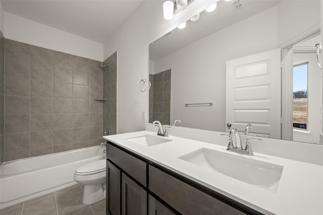 full bathroom featuring tile patterned flooring, vanity, toilet, and tiled shower / bath