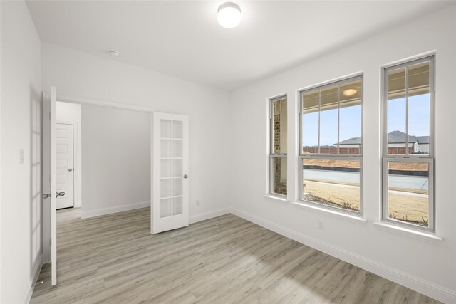 dining area with a healthy amount of sunlight, light hardwood / wood-style flooring, ceiling fan, and a brick fireplace