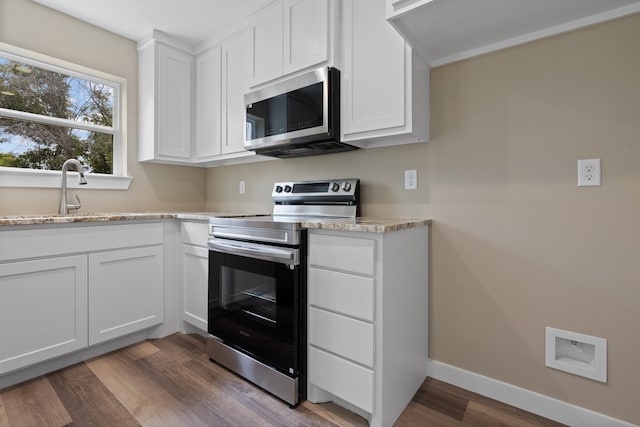 kitchen featuring dark hardwood / wood-style floors, sink, stainless steel appliances, and white cabinets