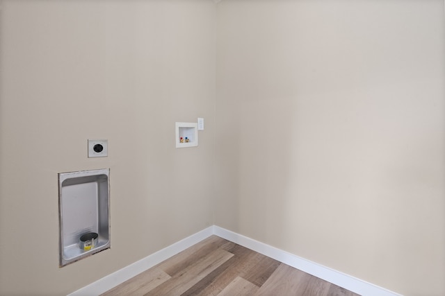 clothes washing area featuring light hardwood / wood-style flooring, hookup for an electric dryer, and washer hookup