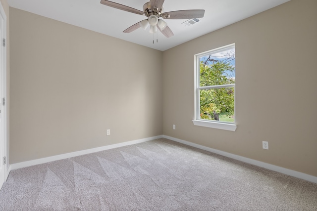 carpeted empty room featuring ceiling fan