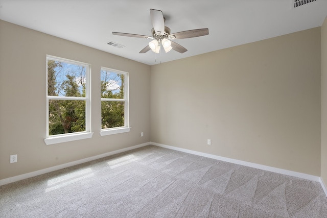 spare room with ceiling fan and carpet