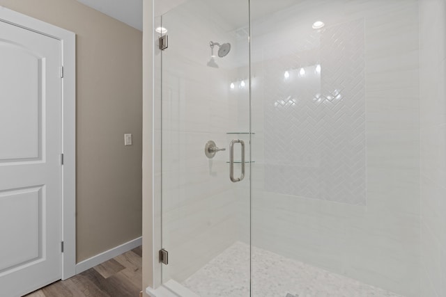 bathroom with walk in shower and wood-type flooring