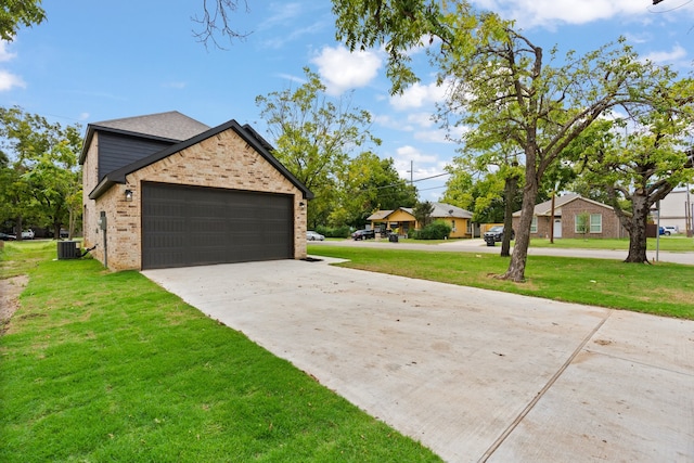 exterior space featuring a garage, a yard, and central air condition unit