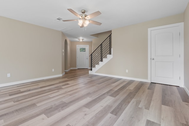 unfurnished living room featuring light wood-type flooring and ceiling fan